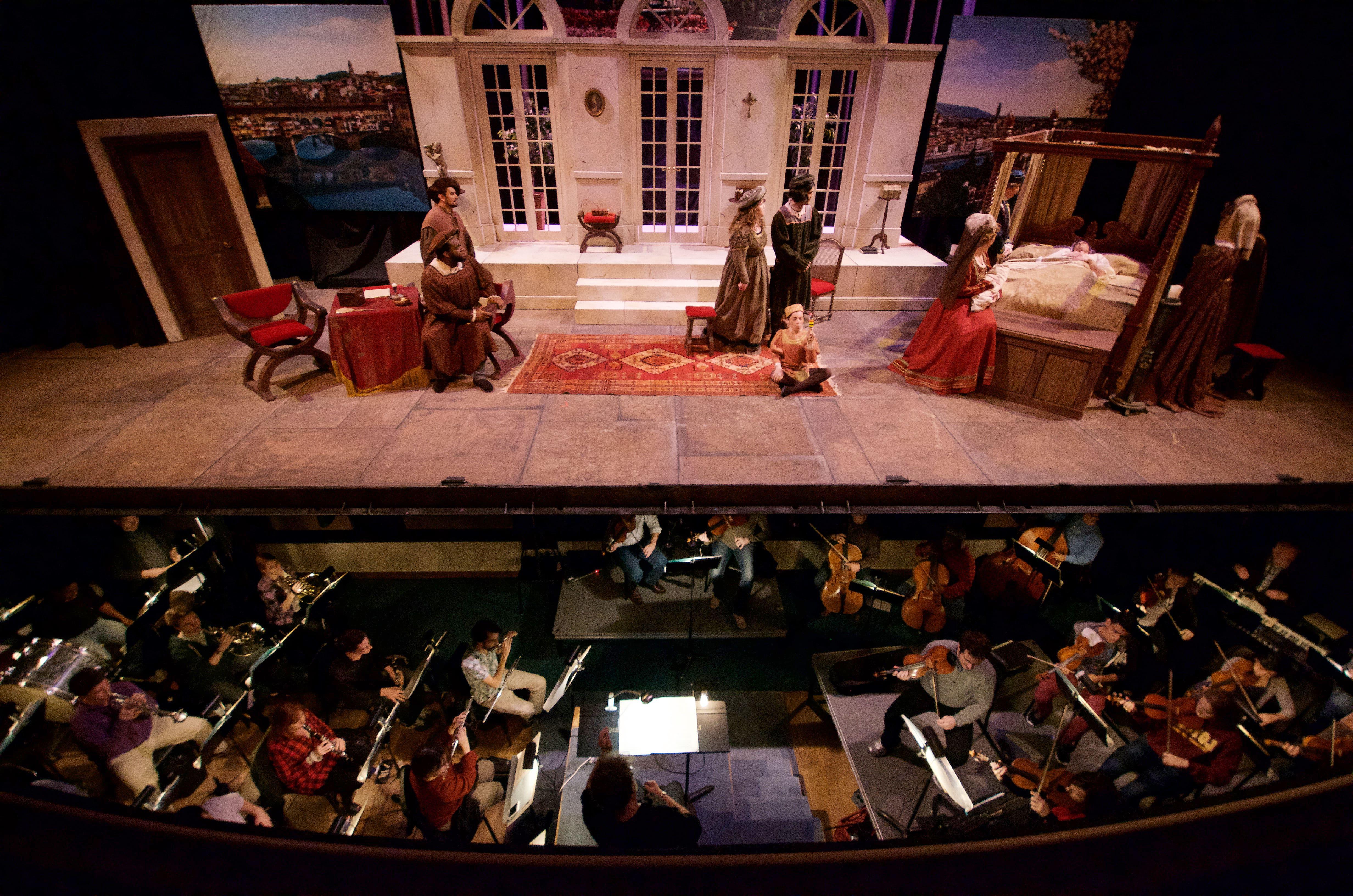 A photo of a previous Loyola Opera production, with a view of the pit orchestra and performers on stage.